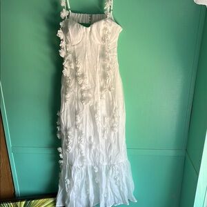 Gorgeous white formal dress with flower appliqués .